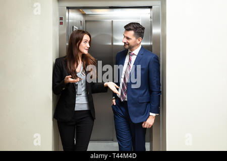 Glückliches junges Paar aus dem Aufzug kommen Stockfoto