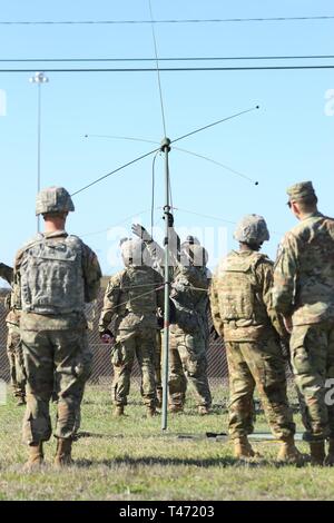 Wagonmaster Soldaten mit 289 Composite Supply Company, 553Rd Combat Sustainment Support Bataillons, 1st Cavalry Division Sustainment Brigade, arbeiten zusammen, um eine Radio Antenne während der Radio Communications sergeant Zeit Training in Fort Hood, Texas, 14. März 2019 eingestellt. Stockfoto