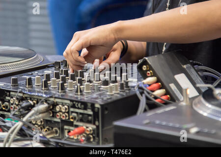 Weibliche Hand spielen DJ-Mixer Stockfoto