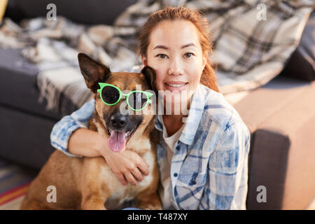 Asiatische Frau posiert mit lustigen Hund Stockfoto