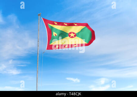 Grenada Fahne weht im Wind über blauen Himmel Hintergrund Stockfoto