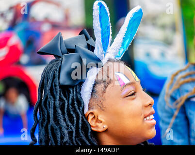 Ein Mädchen trägt bunny Ohren während einer Gemeinschaft Ostereiersuche am Langan Park, April 13, 2019 in Mobile, Alabama. Stockfoto