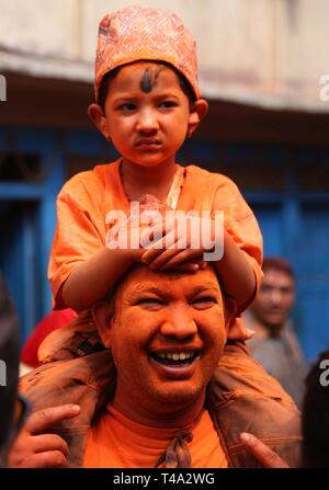 Bhaktapur, Nepal. 15 Apr, 2019. Eine nepalesische Junge nimmt mit seinem Vater in der Feier der Sindoor Jatra Festival in Thimi in Bhaktapur, Nepal, 15. April 2019. Das Festival wird gefeiert der Nepalesischen neues Jahr und den Beginn der Frühjahrssaison in Nepal zu begrüßen. Credit: Sunil Sharma/Xinhua/Alamy leben Nachrichten Stockfoto