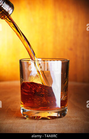 Whisky wird in ein Glas gegossen Stockfoto