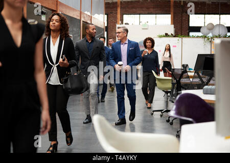 Geschäftsleute, die für Arbeit im hektischen modernen Großraumbüro Stockfoto