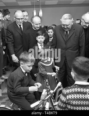 Bundeskanzler Ludwig Erhard besuche Waisen in einem Waisenhaus in Bonn am 20. Dezember 1963, sie mit Geschenken zu überraschen. Das Bild zeigt die Ludwig Erhard (r, vorne) nach der Übergabe der Geschenke in der Mitte des spielende Kinder. | Verwendung weltweit Stockfoto