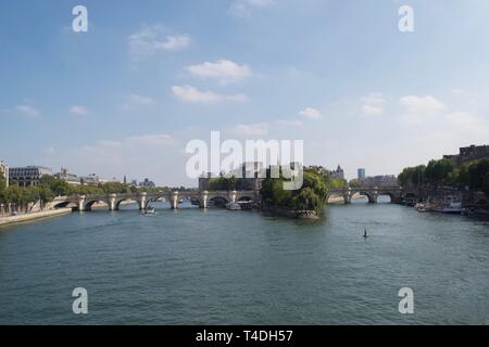 Blick auf die Pont Neuf (Neue Brücke) - älteste Brücke in Paris, die Seine überqueren an einem sonnigen Tag. Blauer Himmel und blauem Wasser; Bäume sind im Blatt. Ein Bo Stockfoto