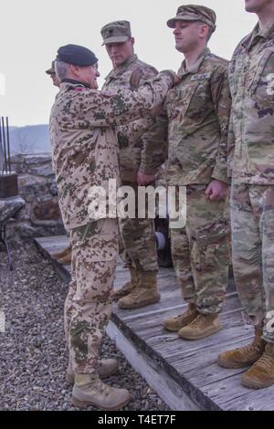 Oberstleutnant Michael Breuer, deutsche Armee Vertrauensdozent an der United States Military Academy in West Point, Auszeichnungen der deutschen Streitkräfte Proficiency Abzeichen der New York Army National Guard Soldaten, nachdem Sie den 12-Mile ruck Teil der besten Krieger Wettbewerb in West Point, New York, 30. März 2019 abzuschließen. Die besten Krieger Wettbewerb statt, März 27-30, 2019, ist eine jährliche Veranstaltung, in der Junior Soldaten Soldaten und Unteroffiziere aus verschiedenen New York Army National Guard Einheiten in mehreren Veranstaltungen bestimmt sind, ihre militärischen Fähigkeiten und Wissen zu testen konkurrieren, sowie Ihre physische Stockfoto