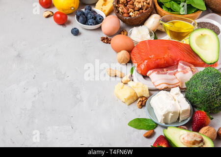 Gesunde Ernährung low carb Keto ketogenic Diät. Hohe gutes Fett Produkte auf grauem Beton Hintergrund Stockfoto