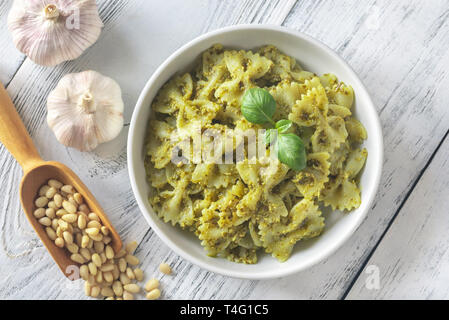 Teil von farfalle mit Pesto mit Zutaten auf die weiße Holztisch Stockfoto