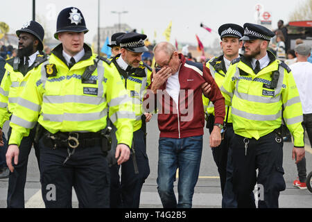 Ein Demonstrator ist entfernt, die von der Polizei während des zweiten Tages der Auslöschung Rebellion Protest auf der Waterloo Bridge in London geführt. Stockfoto