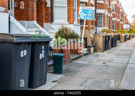 Kunststoff Recycling und Abfall wheelie-Ausgabefächer, oft behindert den Bürgersteig, Warten auf Abholung durch Haringey, nördlich von London, Großbritannien Stockfoto