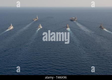 Die französische Marine Nationale Flugzeugträger FS Charles de Gaulle (F91), hinten links, der Flugzeugträger USS John C Stennis (CVN 74), hinten rechts, die französische Air Defence Zerstörer FS Forbin (D620), der Royal Danish Navy Fregatte HDMS Niels Juel (F 363), die geführte-missile Cruiser USS Mobile Bay (CG53), und die geführten Anti-raketen-Zerstörer USS McFaul (DDG74) Segeln in der Ausbildung im Roten Meer, 15. April 2019. Die John C Stennis Carrier Strike Group ist in die USA 5 Flotte Bereich der Maßnahmen zur Unterstützung der Marine im Einsatz für die Stabilität und Sicherheit in der Region zu sichern, c Stockfoto