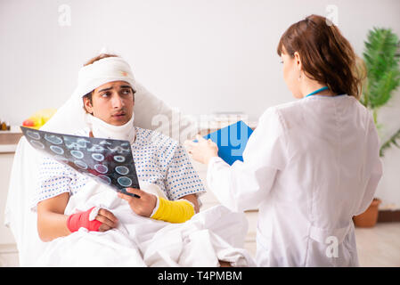 Junger Arzt untersuchen verletzte Patienten Stockfoto