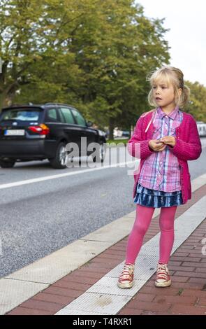 Mädchen (6) am Straßenrand, Kiel, Deutschland, Europa Stockfoto