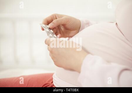 Schwangere Frau mit Tablet in der Hand Stockfoto