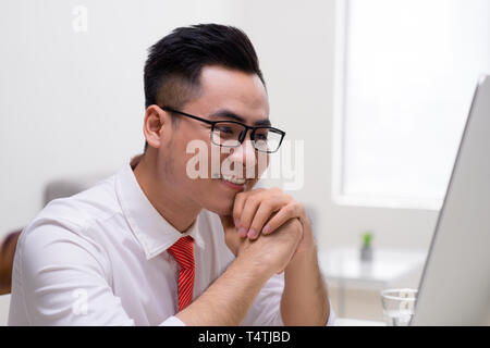 Junge Unternehmer arbeiten im Büro, am Schreibtisch sitzen, Laptop lächelnd.? Stockfoto