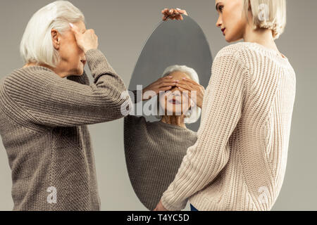 Angenehm nett gealterte Frau ihre Augen schließen Stockfoto