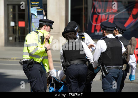 Protestler von der Polizei während eines Aussterbeprotesten in London, Großbritannien, weggetragen. Mehrere Aktivisten wurden während der gesamten Woche verhaftet. Stockfoto