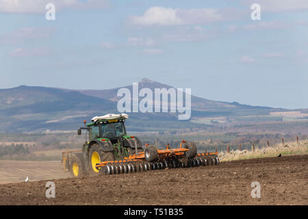 Bennachie in ländlichen Gemeinden ist die Kulisse für diese Szene von einem Bauern ein Feld für die Aussaat vorbereiten Stockfoto