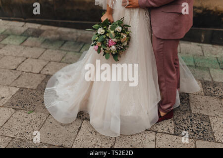 Die Braut hält einen Brautstrauß in ihren Händen, Hochzeit Blumen Stockfoto