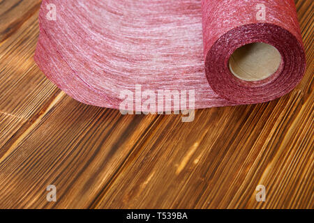 Rolle des Handwerks Material aus für zu Hause Handarbeit auf einer hölzernen Hintergrund aus fichtenbrettern fühlte. Tageslicht. Stockfoto