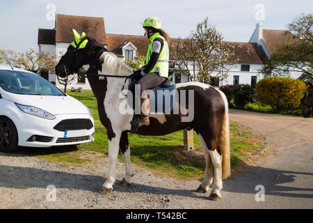 Kent UK. Ein Pferd und Reiter Hi tragen - Sichtbarkeit Fangvorrichtung Pass eine stationäre Auto in der Landschaft. Stockfoto