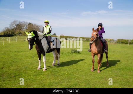 Kent. UK. Zwei Reiter gehen für ein Hack in der Landschaft auf einem schönen sonnigen Tag. Stockfoto