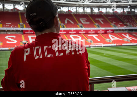 Russian football fan looks at the field and the stands of the football stadium "Otkrytie Arena" of football club "Spartak" in Moscow, Russia Stockfoto