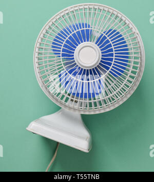 Home mini Ventilator auf Minze pastellfarbenen Hintergrund. Die Erlösung von der Hitze. Stockfoto