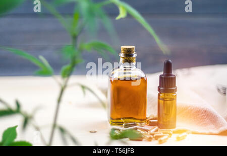 Klar CBD Cannabidiol Kapseln und Cannabis Öl auf Holz- Hintergrund Stockfoto