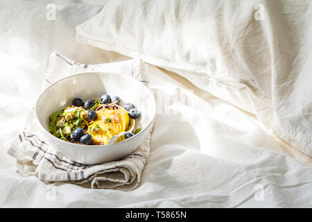 Müsli mit Avocado, Superfoods, Beeren und Früchte in einer weißen Schüssel. Auf Basis pflanzlicher Ernährung Konzept. Stockfoto