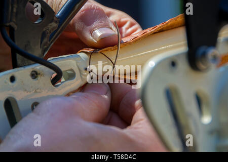 Master arbeiten auf dem Fahrrad Polsterung in Leder. Hand gemacht. Close Up. Stockfoto