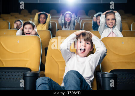 Aufgeregt multikulturellen Freunde gemeinsam Film im Kino. Stockfoto