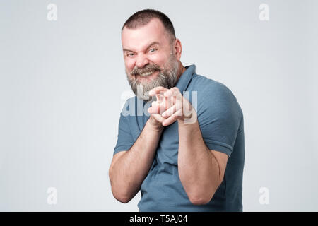 Mai wilde Kerl zieht seine Hände und zeigt seine Zähne, posieren wie ein Tiger. Stockfoto
