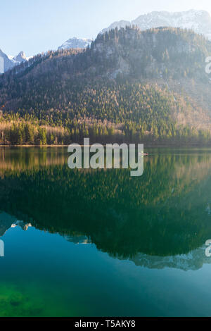 Malerischer Blick auf ein Fischerboot rudern zusammen mit dem großen Landschaft auf das kristallklare Wasser der Vorderer Langbathsee, OÖ, Österreich widerspiegelt Stockfoto