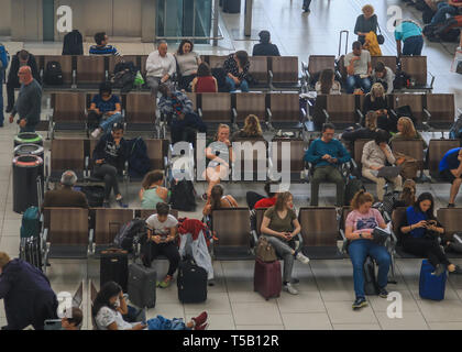 London, Großbritannien. 22 Apr, 2019. Passagiere warten in der Abflughalle auf einer verkehrsreichen Ostern Feiertag Montag, während der Flughafen Heathrow meldet einen Anstieg der Passagierzahlen für die 29 Monate in Folge 6,5 Millionen Passagiere den größten Flughafen der BRITISCHEN im März bestanden, ein Durchschnitt von 210.000 pro Tag. Der Anstieg um 0,5 Prozent gegenüber dem gleichen Monat im Jahr 2018, was eine zusätzliche 1.000 Fahrgäste pro Tag. Credit: Amer ghazzal/Alamy leben Nachrichten Stockfoto