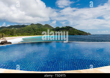 Runde Infinity-Pool mit Blick auf das Meer. Schöne Aussicht auf den Seychellen Insel. Stockfoto