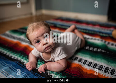 Drei Monate altes Baby boy Verlegung auf Bunt gestreifte Decke Stockfoto