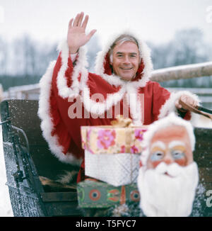 Joachim Fuchsberger in einem Weihnachtsmannkostüm Ca. 1970. Joachim Fuchsberger in einem Santa Claus kostüm Ca. 1970 Stockfoto