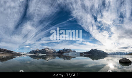 Grönland, Sermersooq, Kulusuk, Schweizerland Alpen, Berge und Wolken im Wasser widerspiegelt Stockfoto