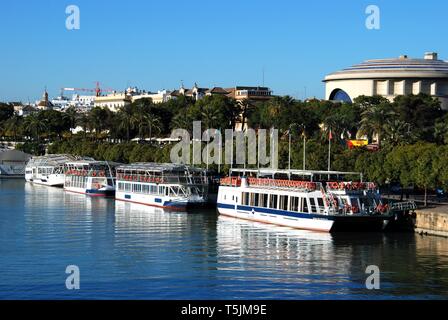 Tour Boote entlang dem Fluss Guadalquivir mit der Maestranza Theater an der Rückseite, Sevilla, Sevilla Provinz, Andalusien, Spanien. Stockfoto