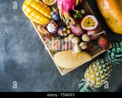 Verschiedene frische Thai Früchte - rambutan, MANGO-, MANGOSTAN, longan, Papaya, Drachenfrucht, sapodilla, Passionsfrucht, Salak, Ananas auf einer hölzernen Fach und Stockfoto