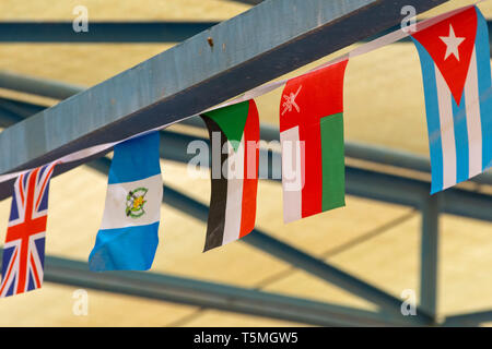 Sudan, Oman, El Salvador, Großbritannien und Kuba Fahnen wehen zusammen in ein Banner für ein Ereignis. Stockfoto