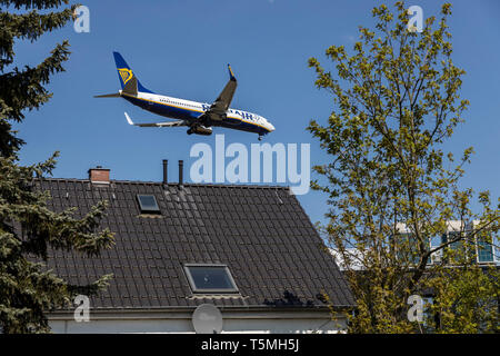 Flugzeuge landen auf DŸsseldorf International Airport, DUS, Deutschland, Häuser im Stadtteil Lohausen, direkt an der Start- und Landebahn Stockfoto