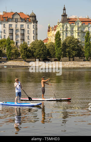 Prag, tschechische Republik - AUGUST 2018: Menschen Paddle Boarding an der Moldau in Prag. Der Fluss verläuft durch das Zentrum der Stadt. Stockfoto