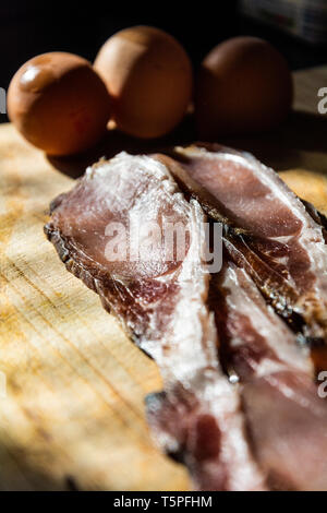 Zwei Scheiben von rohem, Melasse zurück mit Hühnereier auf einem Schneidebrett bereit, in ein warmes Frühstück. Stockfoto