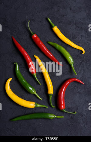 Assoted verschiedenfarbige Peperoni auf dunklem Hintergrund Stockfoto