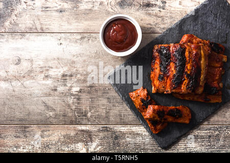 Gegrillte barbecue Rippen auf Holztisch. Ansicht von oben. Copyspace Stockfoto