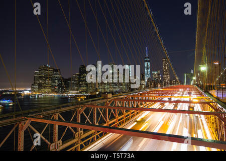 New York City, USA - 04.13.2014: Autos Manhattan verlassen über die Brooklyn Bridge bei Nacht. Stockfoto